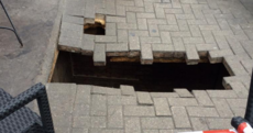 A woman fell into this giant hole that opened 'like a trapdoor' in the street