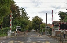 Woman pushing pram struck by barrier at level crossing