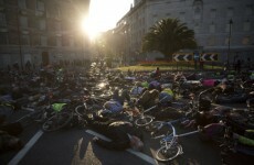 Cyclists hold vigil for woman killed by lorry by lying on the road with their bikes