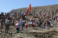 Volunteers pull bodies from the rubble as death toll in Myanmar reaches 113