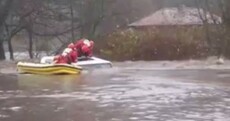Watch: Driver pulled from sunroof after car trapped in rushing flood waters