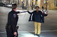 Angry crowds rally after police officer 'shoots teenager carrying broomstick'
