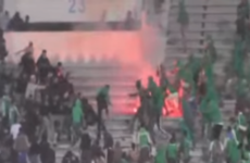 2 dead and 54 injured as fans clash at football stadium