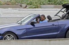 Men exchange high-fives and take selfies after bizarre car chase