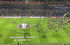Violent clashes forced fans on the pitch and delayed Lyon's Europa League tie against Besiktas