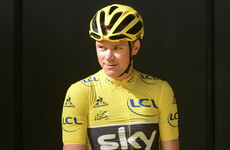Chris Froome climbs into the leader's jersey ahead of Nico Roche