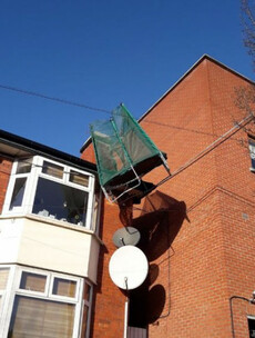 A trampoline was blown onto power cables above a house in Dublin today