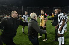 Greek police issue warrant after soccer club owner invades pitch with gun during match