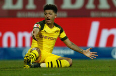 Leaders Dortmund drop more points as fans throw black tennis balls onto pitch