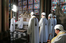 Priests and worshippers in hard hats attend Notre Dame's first mass since fire