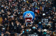 Tens of thousands march in Hong Kong pro-democracy rally after police use tear gas in clashes