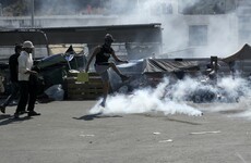 Tear gas fired during migrant protests on Greek island of Lesbos