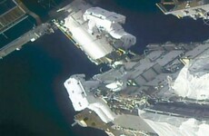 Spacewalking astronauts prepare station for new solar wings