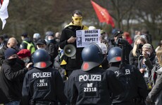 Police clash with protesters as Germany passes law to impose 10pm curfews