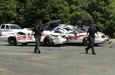 Angry farmer is angry; crushes police cars with tractor