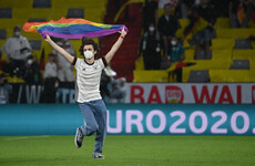 Germany fan with rainbow flag invades pitch during Hungarian anthem as row heats up