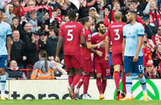 Liverpool close in on Man United as fans boo national anthem