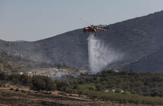 Fire service says Greece wildfires mostly under control, but strong winds still a threat