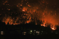 'Rapidly evolving' wildfires in western Canada force tens of thousands to flee