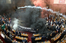 Watch: Several Serbian MPs injured as opposition disrupts parliament with flares and tear gas