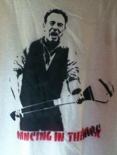 Bruce Springsteen swaps his guitar for a hurley