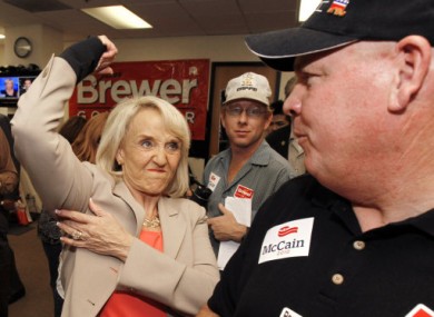 Gov. Brewer (left) poses for supporters while campaigning for Senator John McCain last week. 