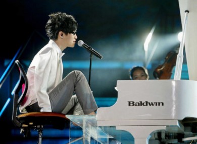Armless pianist Liu Wei plays the piano with his feet whilst he sings during the final of the TV show China's Got Talent held at the Shanghai Stadium.