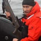 Putin holds a crossbow during a scientific expedition to study grey whales this year.