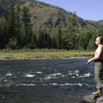 Putin fishes, topless, in the headwaters of the Yenisey River. 
