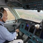Putin takes the co-pilot's controls as part of the emergency effort to drop water over forest fires in the Ryazan region in August.