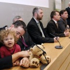 Daisy Gogarty (18 months) sits in the arms of her father, Green Party TD Paul and other members of the Greens as leader John Gormley speaks during the press conference. AP Photo/Peter Morrison
