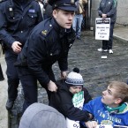 Gardaí remove Sinn Fein protesters from inside the gates of government buildings. (AP Photo/Peter Morrison)
