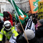 Sinn Fein protestors tussle with Gardai at the gates of government buildings in Dublin. Julien Behal/PA Wire
