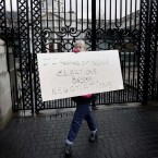 Later, a protester holds a banner reading 