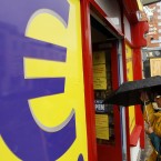 A woman enters a euro discount store in south Dublin. The euro initially rallied, but later slid, against foreign currencies as investors disregarded the benefits of an Irish bailout. (AP Photo/Peter Morrison)