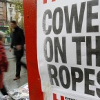 A newspaper seller displays the Evening Herald headline in central Dublin. (AP Photo/Peter Morrison)