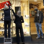 Staff put up a sale sign in central Dublin. Brian Lenihan was earlier told that Ireland's biggest two banks would need an immediate capital injection of €5bn. (AP Photo/Peter Morrison)