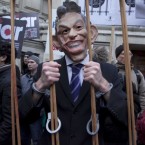 A protestor in a Tony Blair mask makes his point outside the London venue where the former British prime minister was giving his evidence to the Chilcot Iraq Inquiry today. Blair admitted he had diregarded legal advice that the invasion of Iraq without UN backing was illegal under international law. He said he regretted 