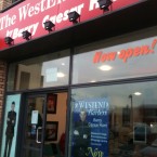 The WestEnd Barber shopfront is pasted with images of Apprentice Barry C Hunt.
