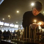 A clergyman lights candles at a site of a blast at Domodedovo airport near Moscow where a suicide bomber killed scores of people on Monday.