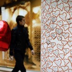 A Bulgarian carries red heart balloon for Valentine's day as he passes by a column decorated with hearts in Sofia. (AP Photo/Valentina Petrova)