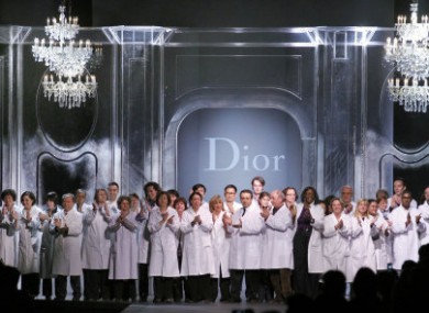 Dior fashion house employees acknowledge applause at the end of the Fall-Winter 2012 ready to wear collection today.
