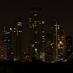 Few lights remain on buldings as most offices join the Earth Hour, a global campaign to switch off their light for one hour to high light the campaign against climate change Saturday, March 26, 2011 in Manila's financial district of Makati, Philippines. (AP Photo/Pat Roque)