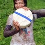 A delighted Jo Guest, 14, from Wolverhampton, holds her prize cheese after she won the woman's race yesterday. (Pic: Tim Ireland/PA Wire)