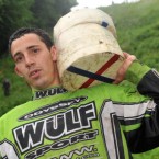 That nasty-looking fall didn't stop him: Chris Anderson, 23, from Brockworth holds his prize cheeses after he won all three races in the Cheese-Rolling on Coopers Hill. (Pic: Tim Ireland/PA Wire)