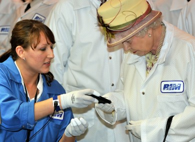 Her majesty gets to grips with a Blackberry last year.