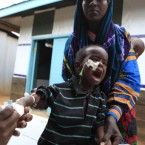 A Somali boy screams as a medical worker replaces his IV needle, for injecting medicine as part of his treatment for malnutrition, at a Doctors Without Borders hospital in Dagahaley Camp, outside Dadaab, Kenya, on 15 July, 2011. East Africa's drought is battering Somali children, hundreds of whom have been left for dead on the long, dry journey to the world's largest refugee complex in Dadaab, northern Kenya. UNICEF on Thursday called the drought and refugee crisis