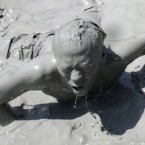 A South Korean man participates in the Boryeong Mud Festival at Daecheon Beach in Boryeong , South Korea, on 17 July, 2011. The 14th annual mud festival features mud wrestling, mud sliding and a mud king contest. (AP Photo/Ahn Young-joon)