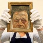File photo dated 27/10/2010 of Sotheby's employee Chloe Stead holding 'Self Portrait with a Black Eye' by British artist Lucian Freud at Sotheby's auction house, London. (PA Image)