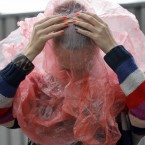 Reanne Vantoor from the Netherlands takes cover from the rain. (Mark Stedman/Photocall Ireland)